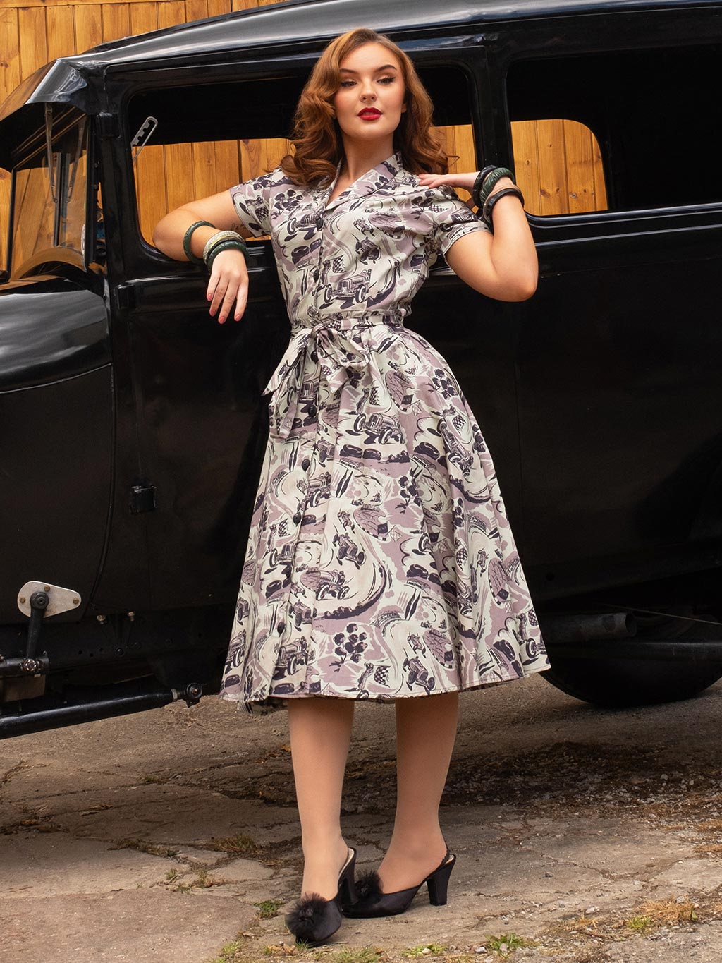 Model wearing Lucy dress in Remus Racetrack print at vintage car event