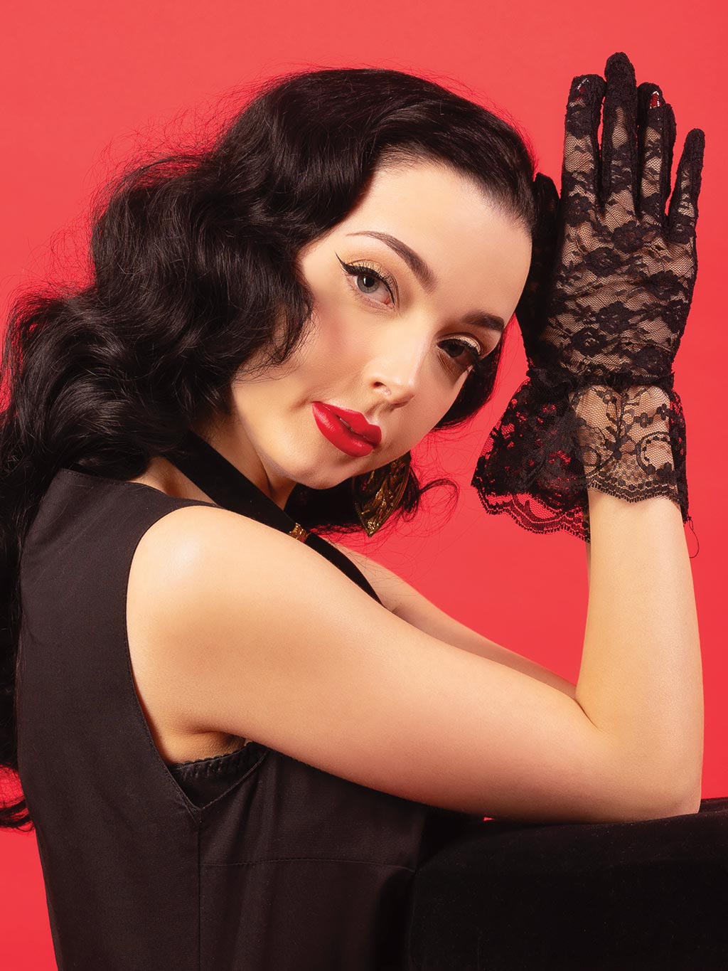 Elegant black floral lace gloves on model's hands