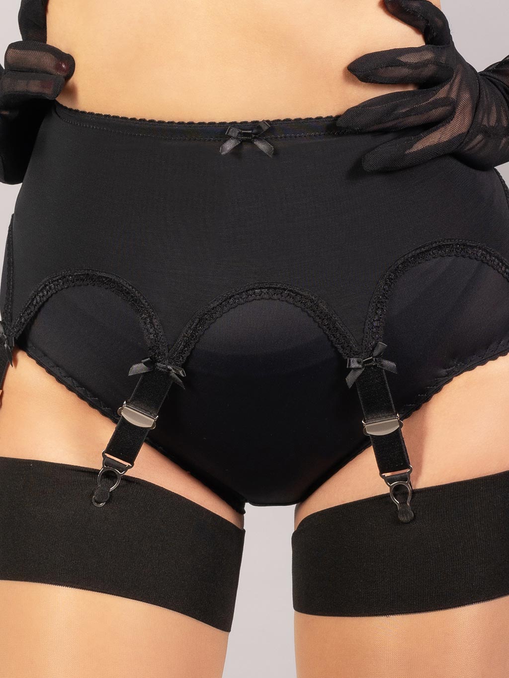 close up pull on black suspender belt and contrast stockings