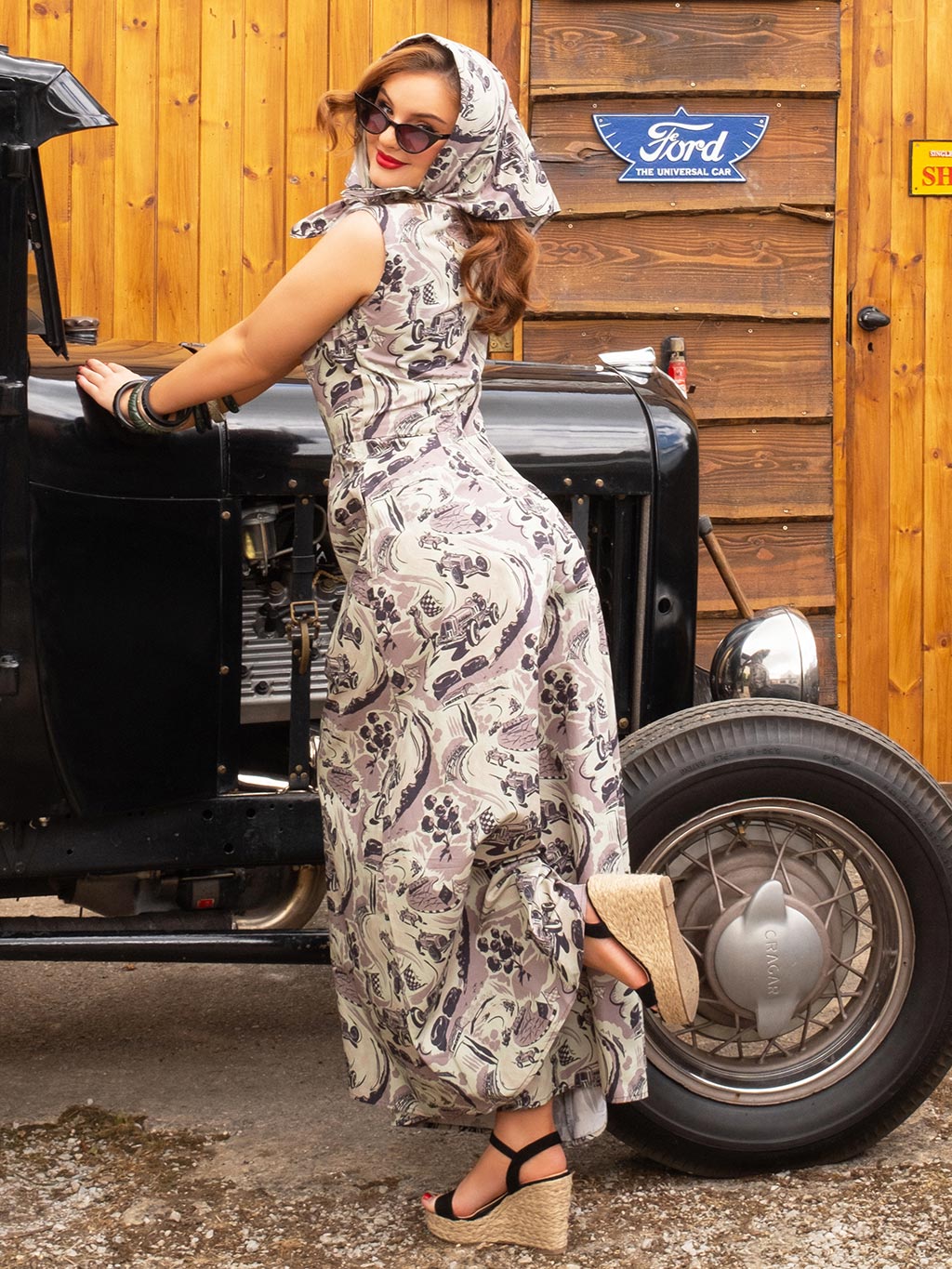 Retro-styled model with vintage racing headscarf and jumpsuit, ideal for Goodwood Revival