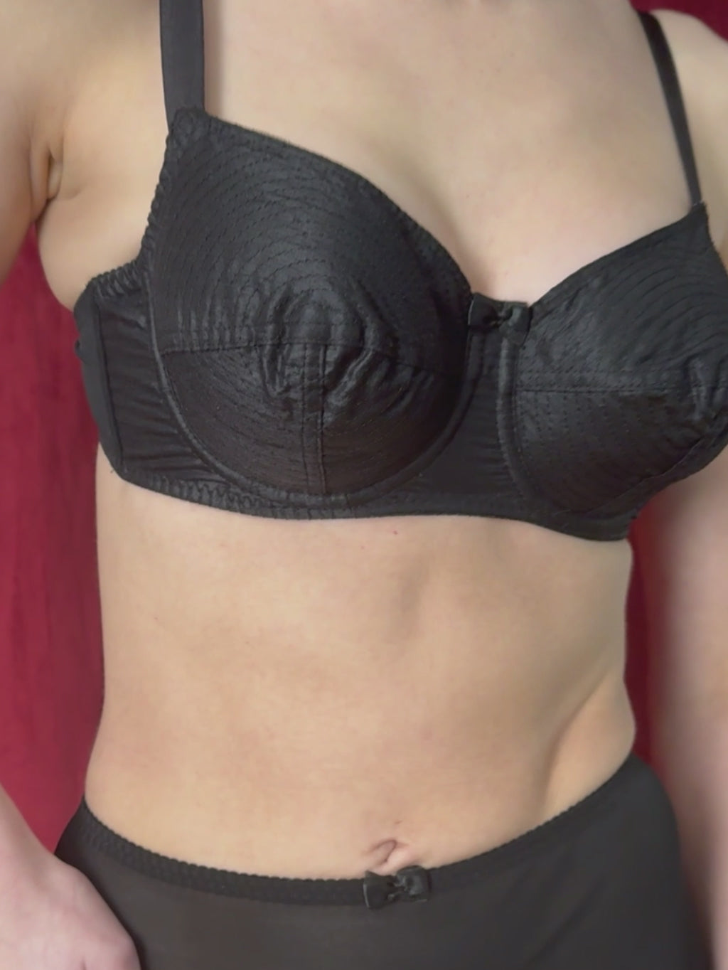 Close-up of black whirlpool bra showing vintage circle stitching detail