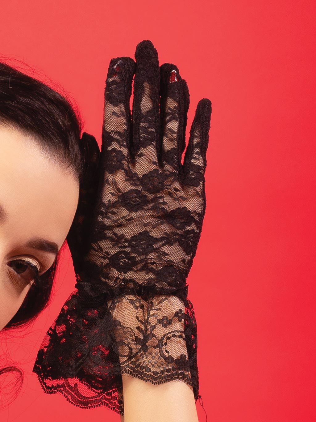 Close-up of intricate floral pattern on black lace gloves