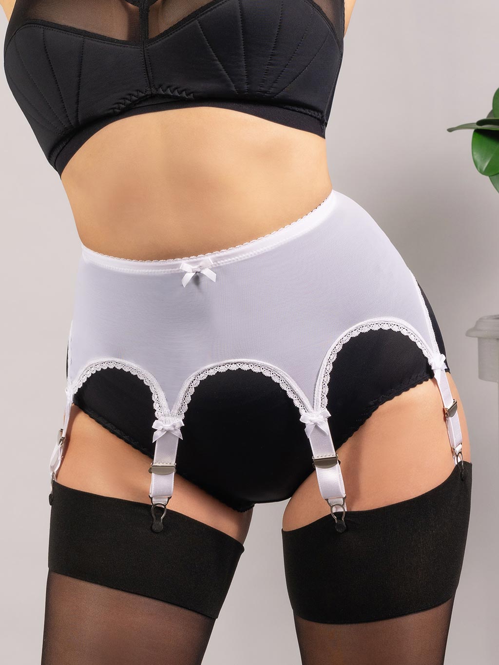 close up of white pull on powermesh suspender belt worn with black lingerie and stockings